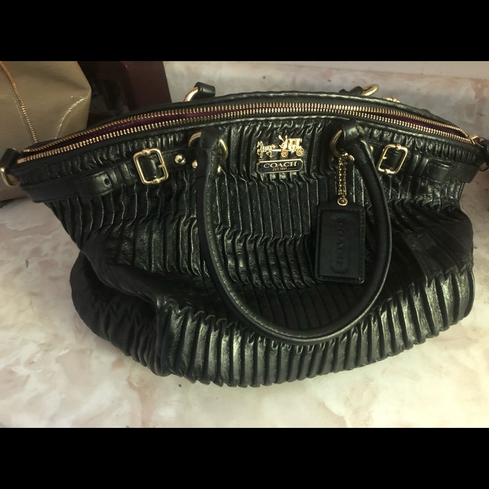 Black coach handbag with purple inside lining